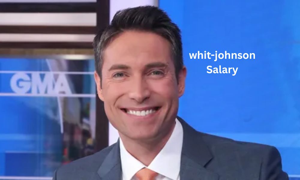 Whit Johnson, co-anchor of ABC's Good Morning America weekend edition, at the news desk in a professional broadcast studio.