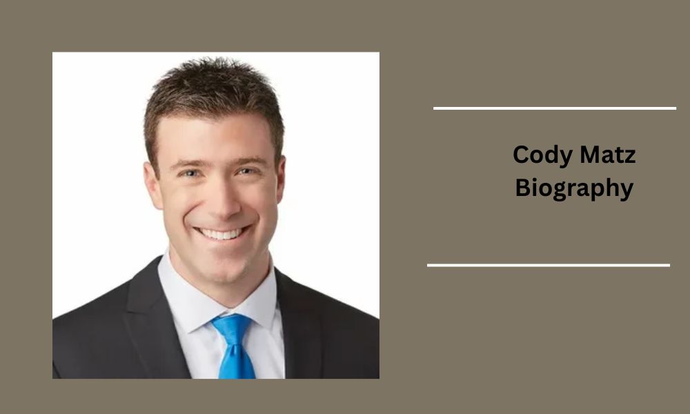 Cody Matz, FOX 9 Minneapolis meteorologist, smiling on set. Minnesota native and married to Dr. Jeff Sachs since 2019.